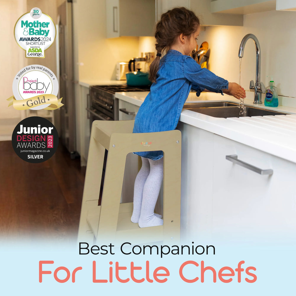 adjustable toddler tower  positioned at kitchen sink for easy reach